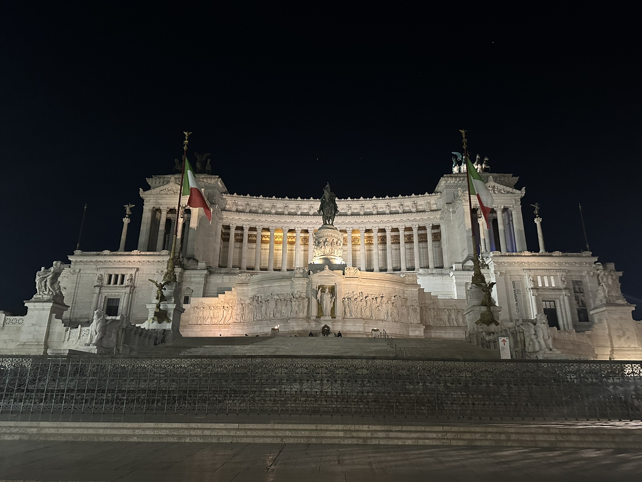 Illuminated Vittoriano monument in Rome before sunrise