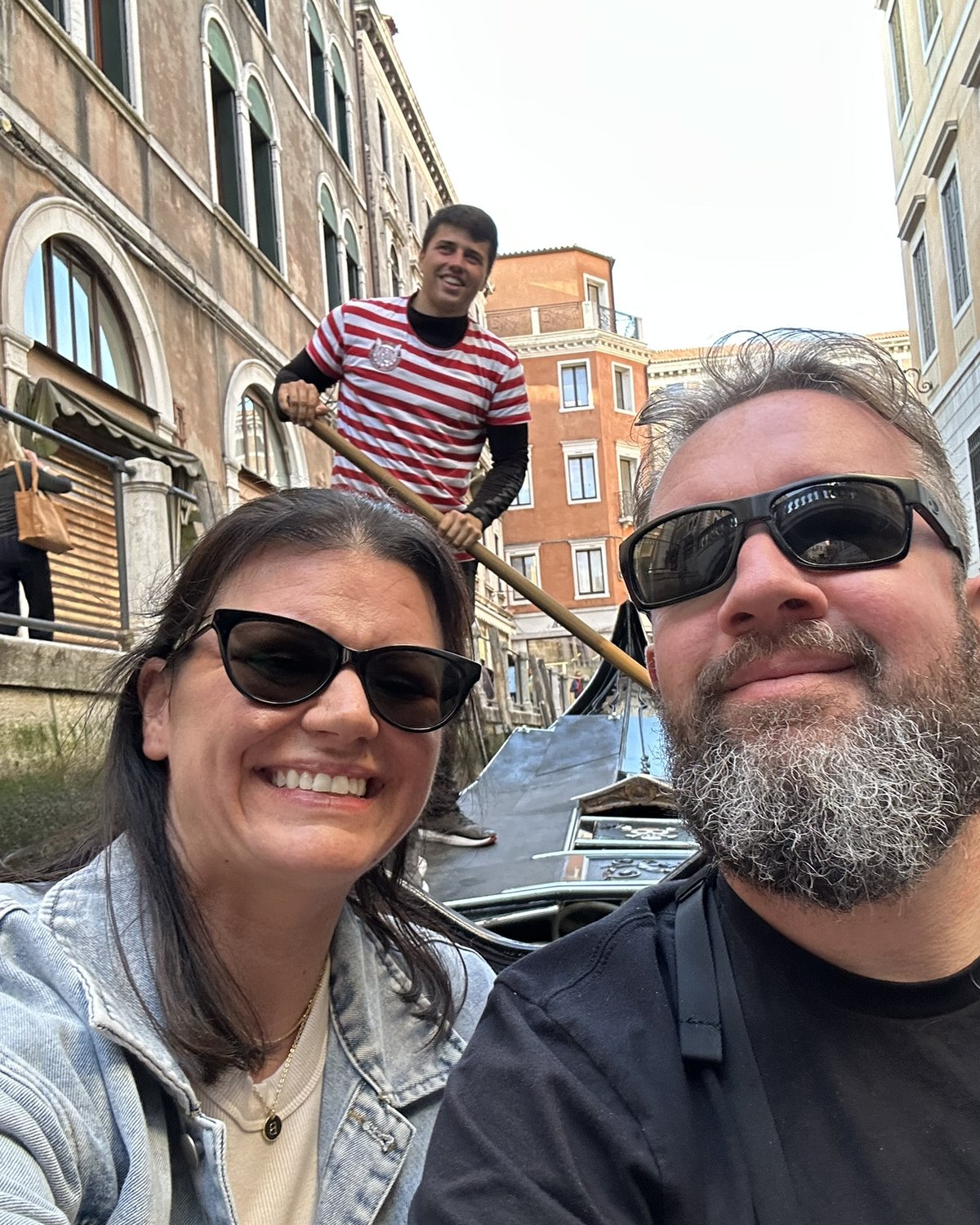 Couple taking a selfie during a gondola ride in Venice